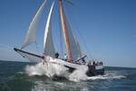 Spes Mea sailing through the waves with spray at the bow