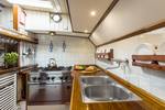 Galley with a cooker and stainless-steel worktop on the Spes Mea