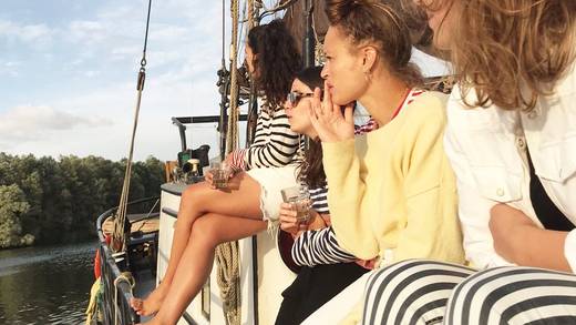 Friends enjoying time together on the deck of a sailing ship