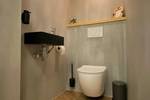 Toilet with a black washbasin aboard the Summertime