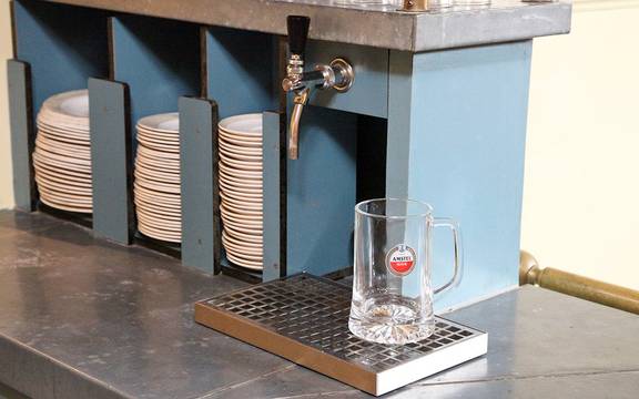 Beer tap and crockery in the galley of the Sybaris