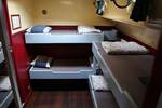 Cabin with bunk beds and a wooden floor on the Sybaris