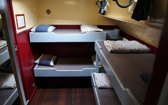 Cabin with bunk beds and a wooden floor on the Sybaris