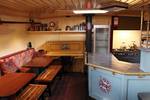 Wooden dining table and benches beside the galley of the Sybaris