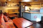 Seating area beside the light blue galley of the Sybaris