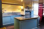 Light blue galley with a kitchen island on the Sybaris