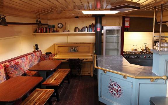 Wooden dining table and benches beside the galley of the Sybaris