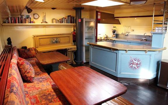 Seating area beside the light blue galley of the Sybaris