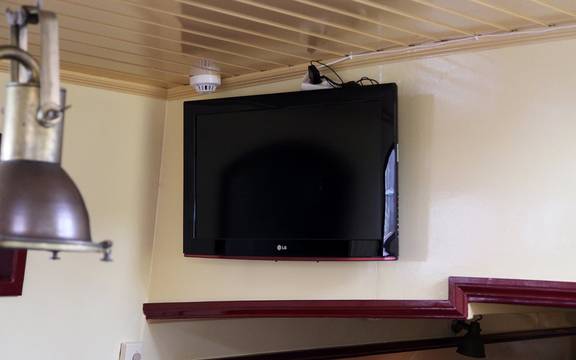 Wall-mounted television in the saloon of the Sybaris