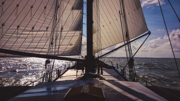 View over the bow beneath the sails of the Sybaris