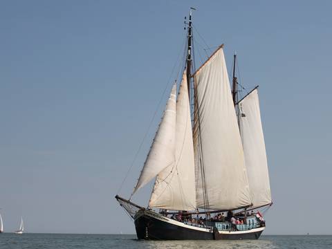 Sybaris under white sails, viewed from the bow