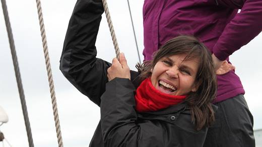 Young guest helping to hoist a sail on the Sybaris