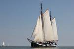 Clipper Sybaris under white sails on the water