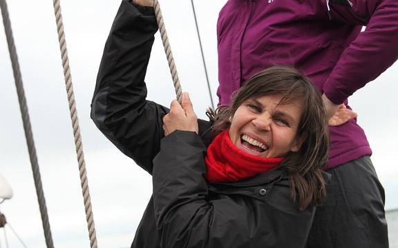 Young guest helping to hoist a sail on the Sybaris