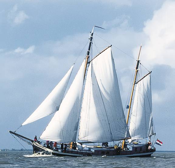 Clipper Sybaris under full white sails, viewed from the side
