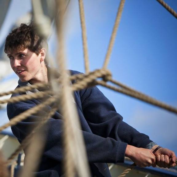 Sailor handling a rope aboard the Thalassa