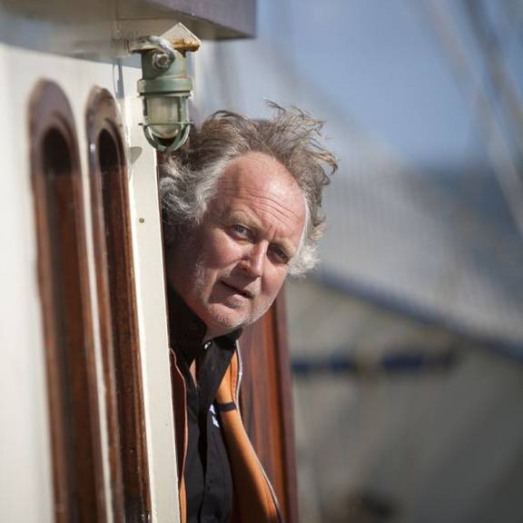 Captain Jacob Jan Dam looking out of the doorway of the Thalassa