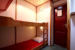 Cabin with a wooden bunk bed on the Tsjerk Hiddes