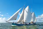 Clipper Utopia under full sail on the water