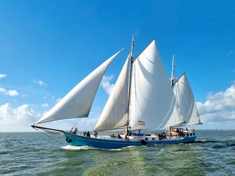 Clipper Utopia under full sail on the water