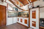 Galley with white cabinets and wooden trim on the Vriendentrouw