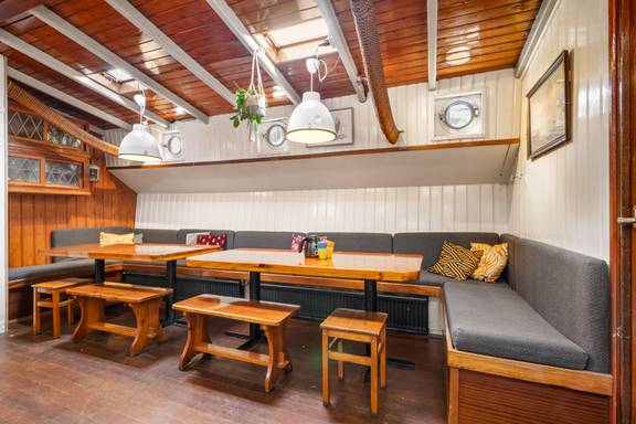 Seating area with wooden tables and benches in the Vriendentrouw