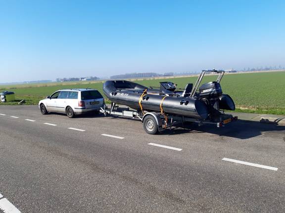 RIB of the Vrijheid on a boat trailer beside the road