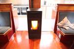 Lit stove between the benches in the saloon of the Vrijheid