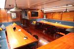 Saloon of the Vrijheid with wooden dining tables and benches