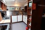 Double sink and storage cabinets in the galley of the Vrijheid