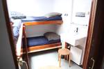 Cabin with bunk beds and a washbasin on the Vrijheid