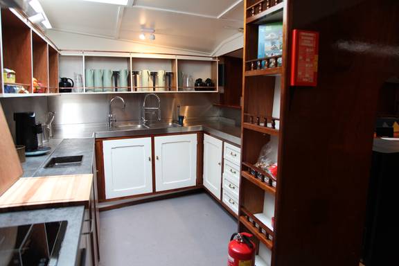 Double sink and storage cabinets in the galley of the Vrijheid