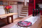Dining table set beside the stairs in the saloon of De Vrouw Dina