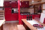 Red galley and wooden dining tables on De Vrouw Dina