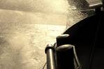 Water spraying beside the hull of De Vrouw Dina while sailing