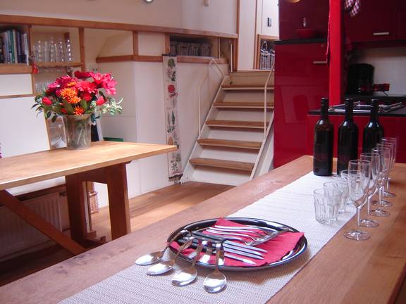 Dining table set beside the stairs in the saloon of De Vrouw Dina