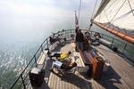 Guests relaxing on the deck of 't Wapen fan Fryslân while sailing