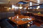 Saloon of 't Wapen fan Fryslân with wooden dining tables and dark benches