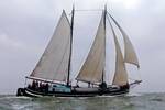 Clipper Waterman under white sails on open water