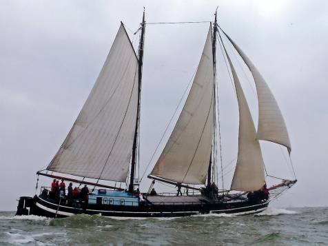 Clipper Waterman under white sails on open water