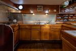 Wooden cabinets and worktop in the galley of the Waterman
