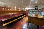 Saloon of the Waterman with long wooden tables