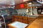 Galley with wooden cabinets and a worktop on the Waterman