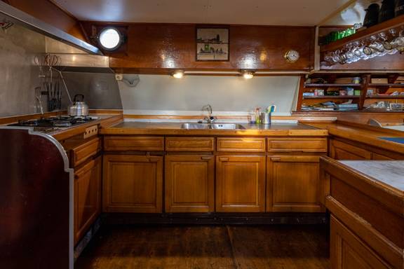 Wooden cabinets and worktop in the galley of the Waterman