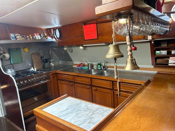 Galley with wooden cabinets and a worktop on the Waterman