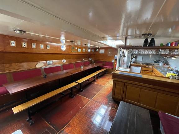 Saloon of the Waterman with long wooden tables
