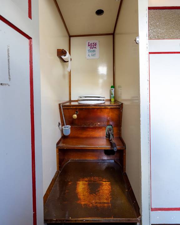 Marine toilet with a wooden surround on the Waterman
