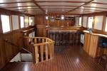 Wooden deckhouse with tables and chairs on the Willem Barentsz