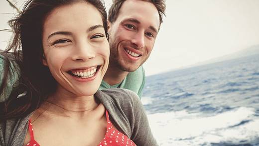 Couple taking a selfie aboard a sailing ship