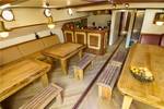 Saloon of the Gulden Belofte with wooden dining tables and benches